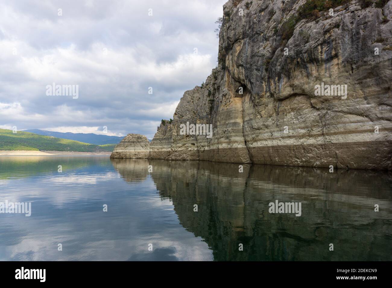 Reflection of rocks in water on a cloudy day Stock Photo