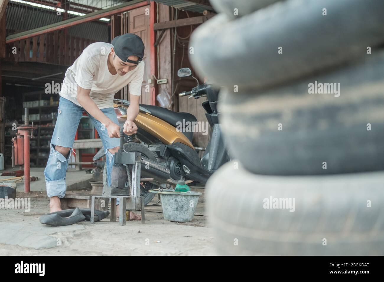 Tire patcher prepares a traditional press before patching the inner