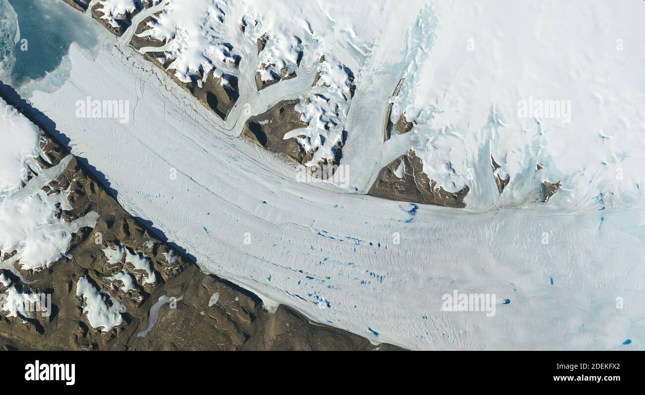 Meltwater lakes form on the surface of Greenland’s Petermann Glacier, seen here in a June 2019 Landsat image. A new study finds that the number – and elevation – of meltwater lakes in Greenalnd is increasing. How do scientists know? Earth’s glaciers and ice sheets as seen from space – some spanning nearly 50 years – are providing scientists with new insights into how the planet’s frozen regions are changing. Handout Photo by NASA/ABACAPRESS.COM Stock Photo