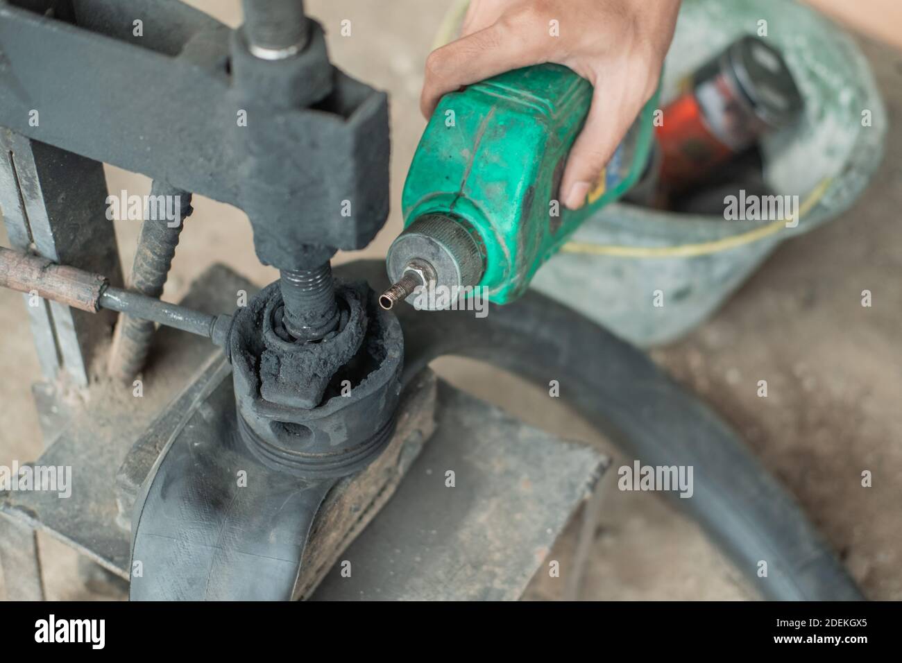 close up of tire repairman's hand when pouring fuel on a traditional