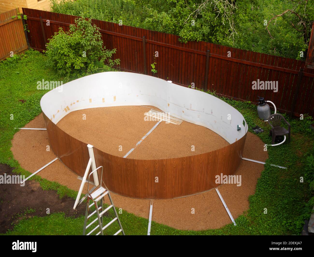 new above ground pool maintenance in a yard, outdoor shot Stock Photo