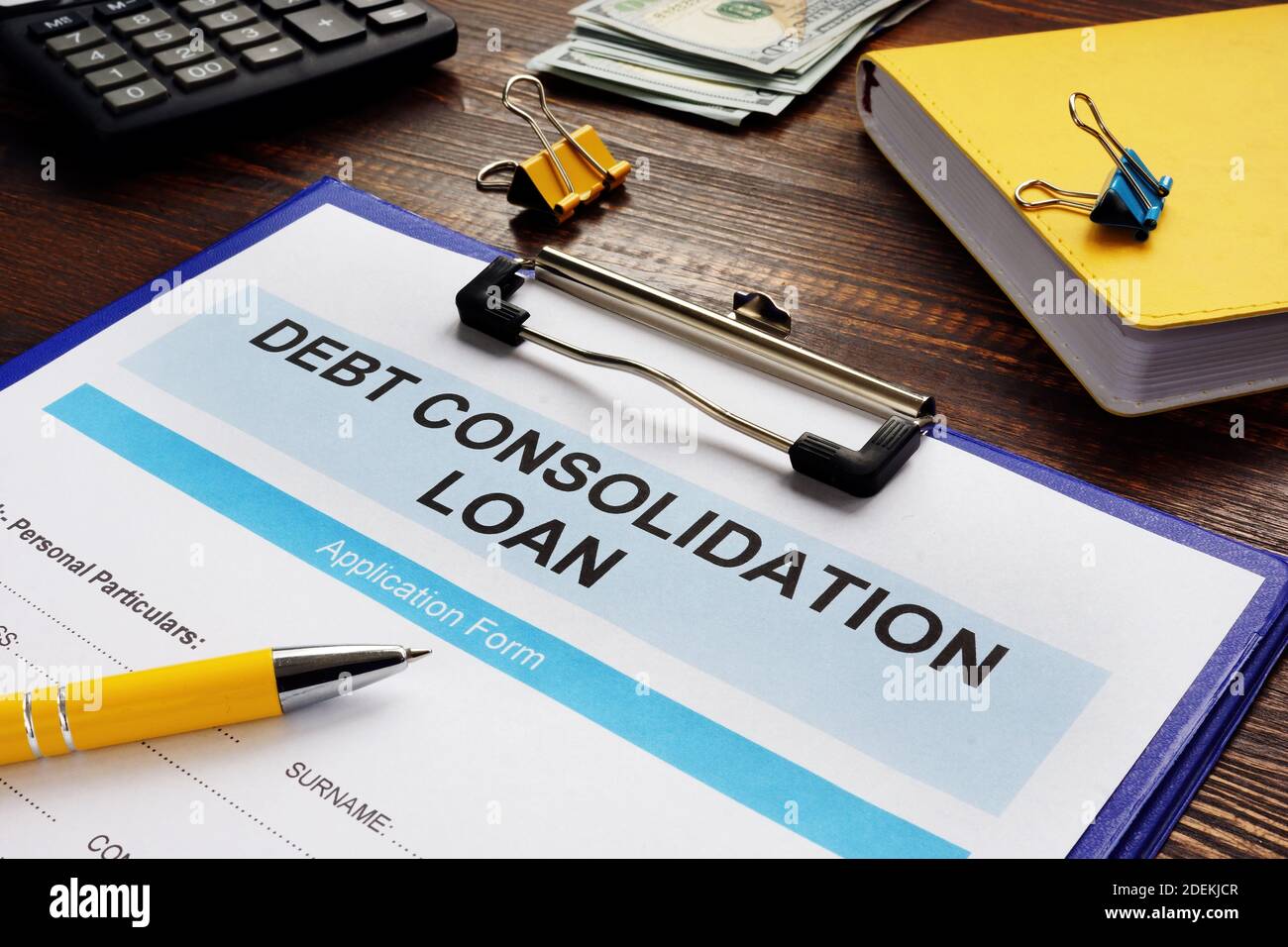 Debt consolidation loan form, notepad and calculator. Stock Photo