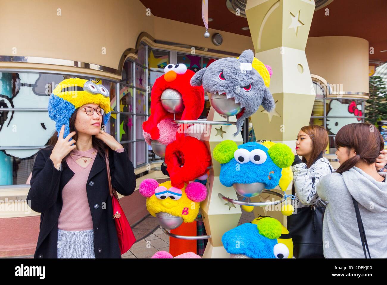 A visitor trying out a cartoon character hat ata theme park in Osaka, Japan Stock Photo