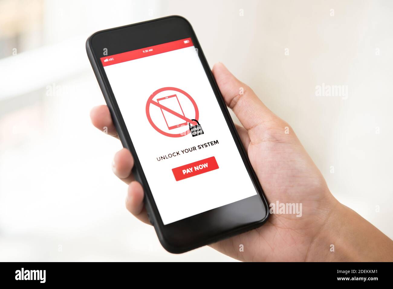 Hand holding smartphone that the system being locked by ransomware, showing on screen - cyber attack concept Stock Photo