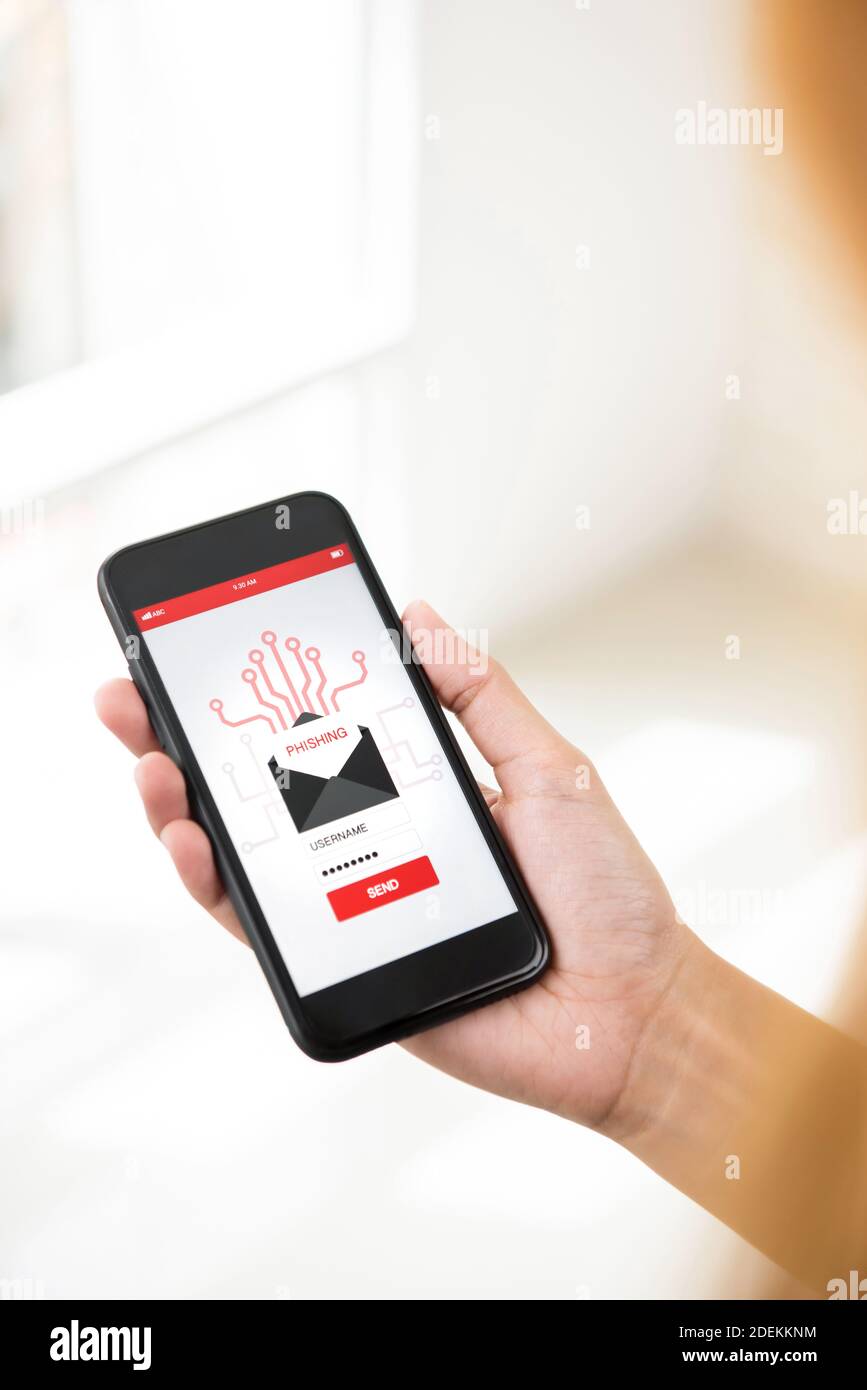 User looking at smartphone  screen considering before sending back sensitive information to scam phishing email Stock Photo