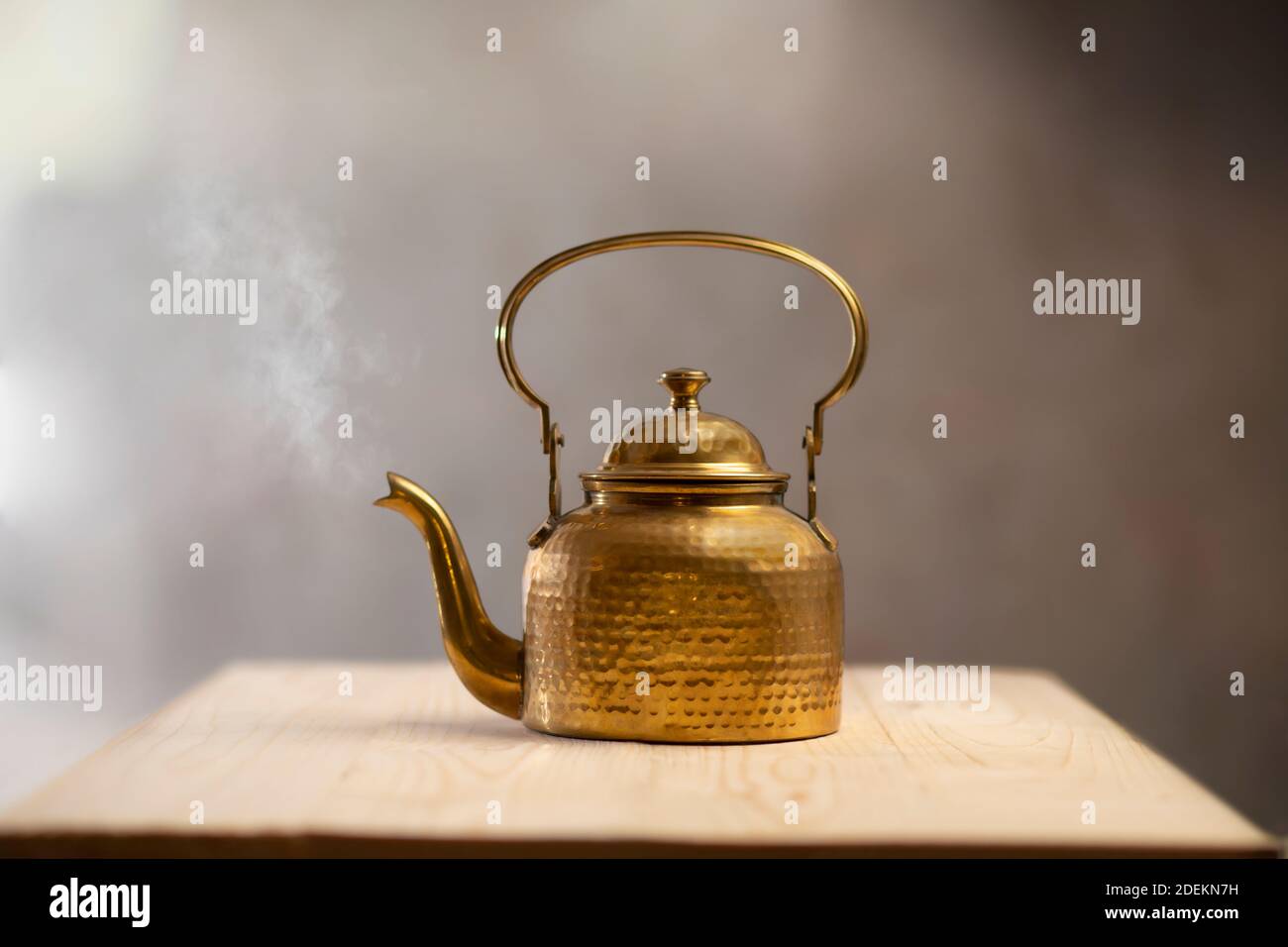 Brass kettle blowing hot air kept on a table Stock Photo Alamy