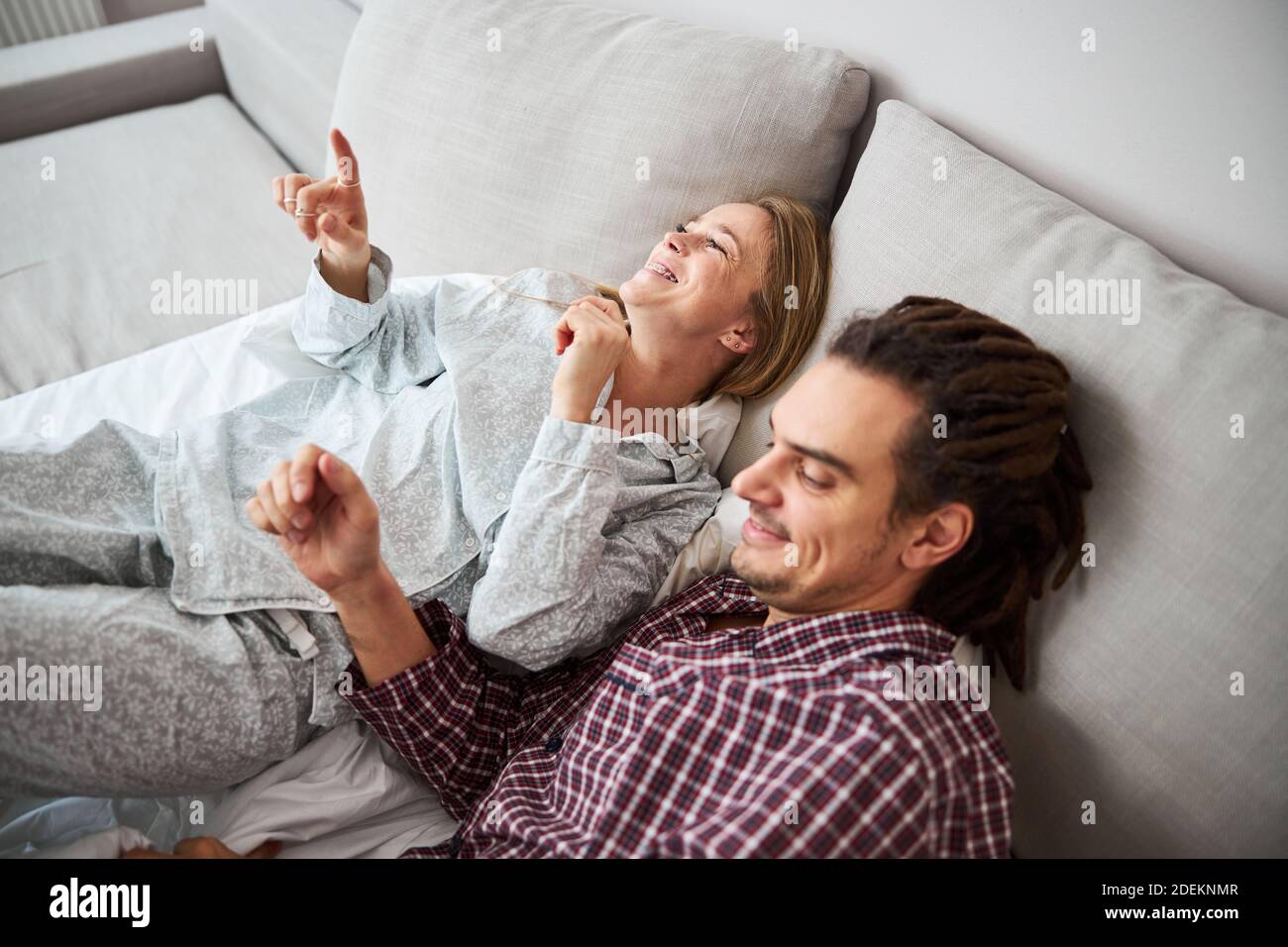 Happy couple in love resting on couch at home Stock Photo - Alamy