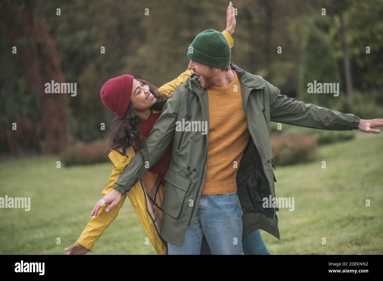 Cute couple walking in the park and looking happy Stock Photo - Alamy