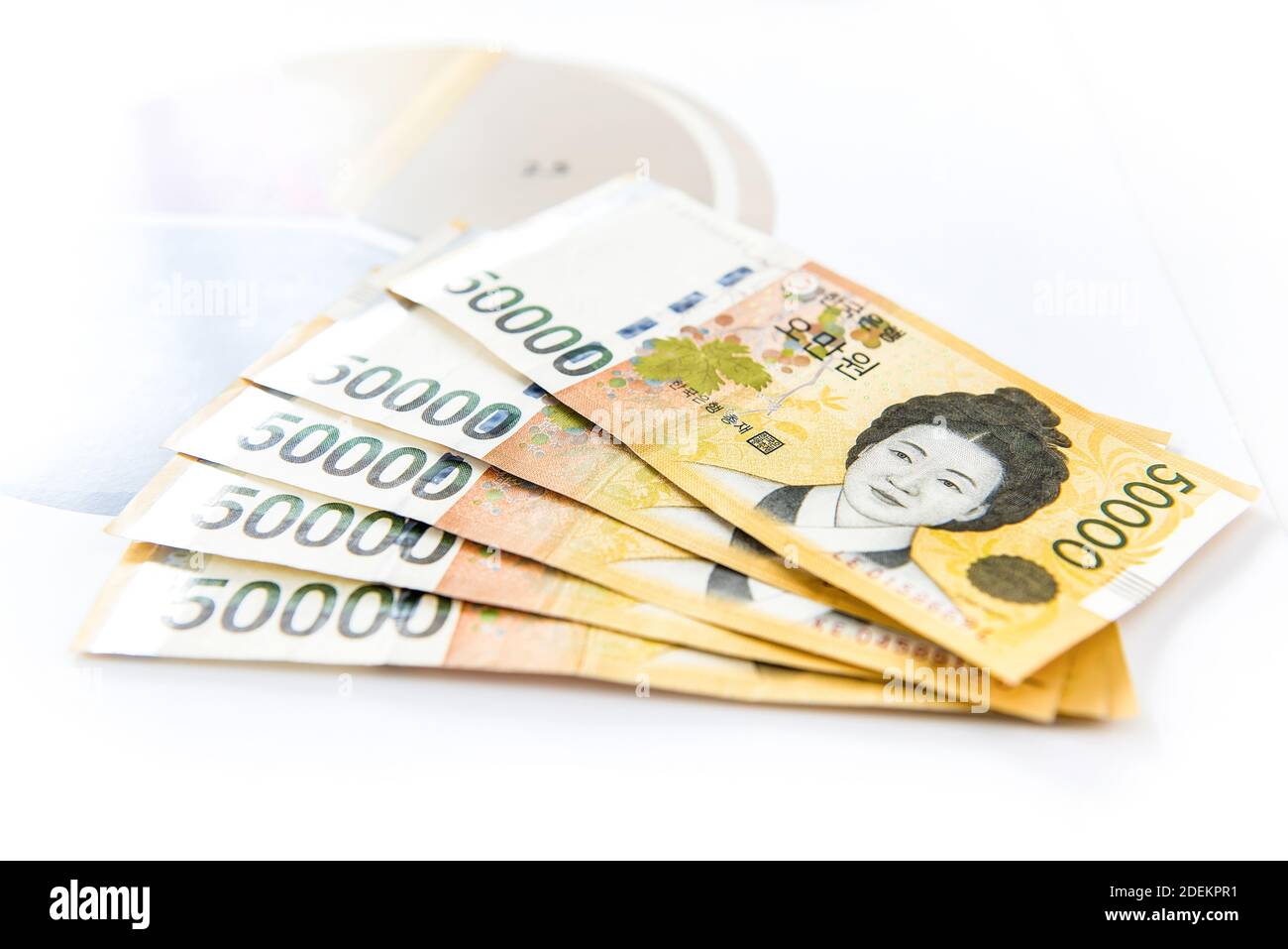 Thousands of South Korean won money in form of banknotes on paper with blurred pie chart in  background Stock Photo