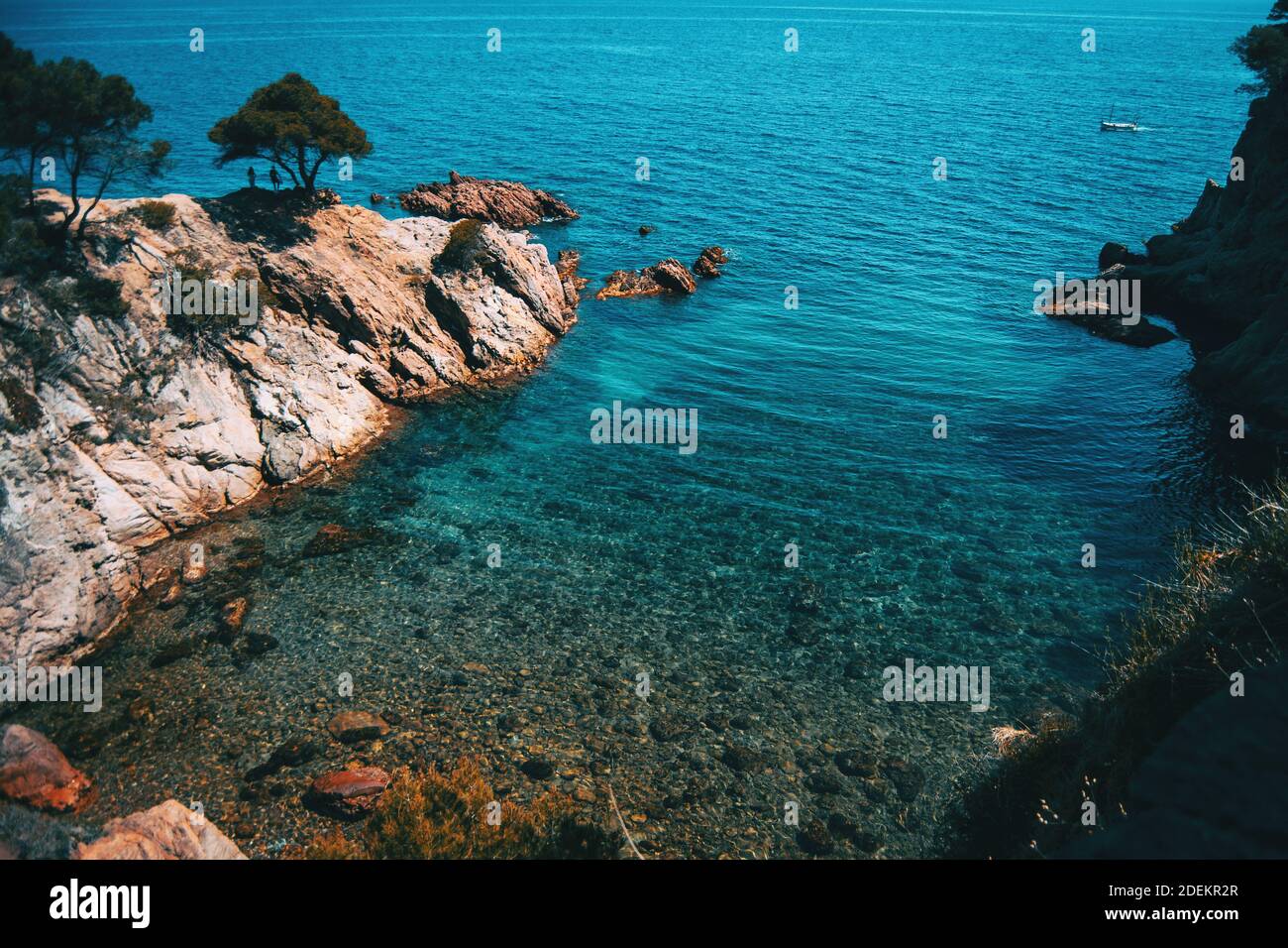 Seascape of a beautiful small cove with shallow crystalline waters on a sunny day Stock Photo