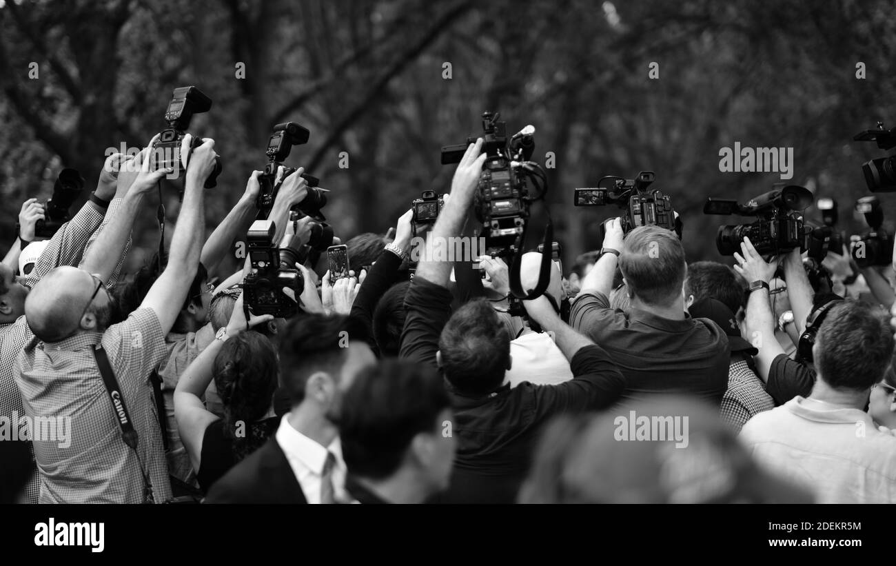 A media pack consisting of reporters and camera operators surround Roger Federer in a park the day after he won the 2017 Australian Open. Stock Photo