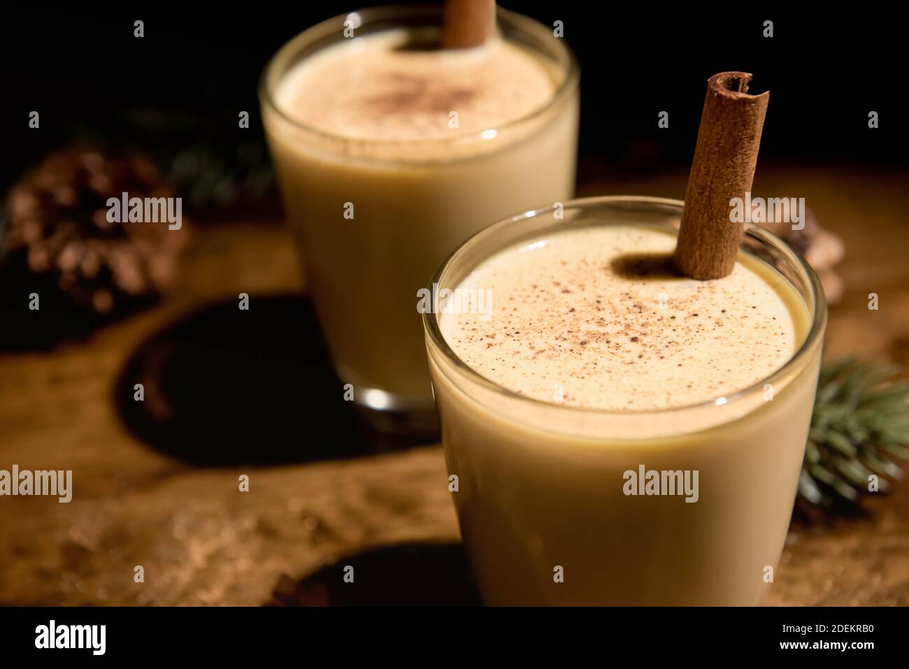 Eggnog with cinnamon and nutmeg for Christmas and winter holidays. Homemade  eggnog in glasses on wooden table surface, shallow depth of the field, cop  Stock Photo - Alamy