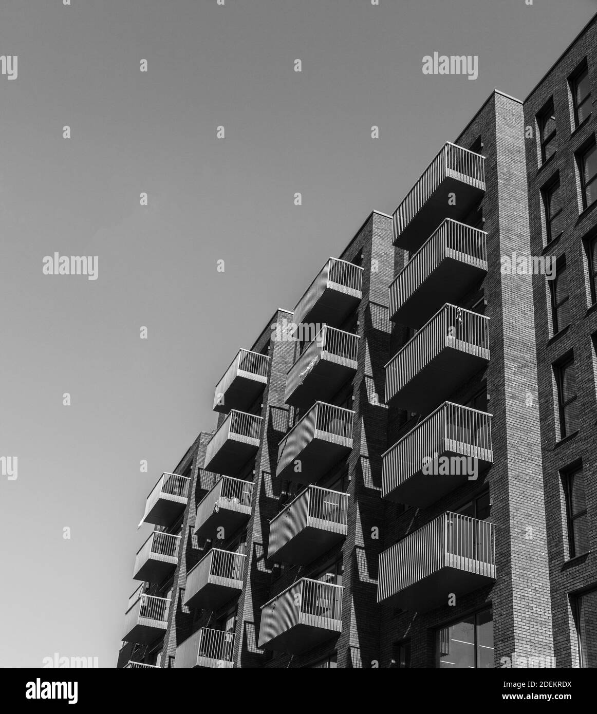 Apartment block with symmetrical railed balconies in Tower Hamlets, London,England,UK. In monochrome Stock Photo