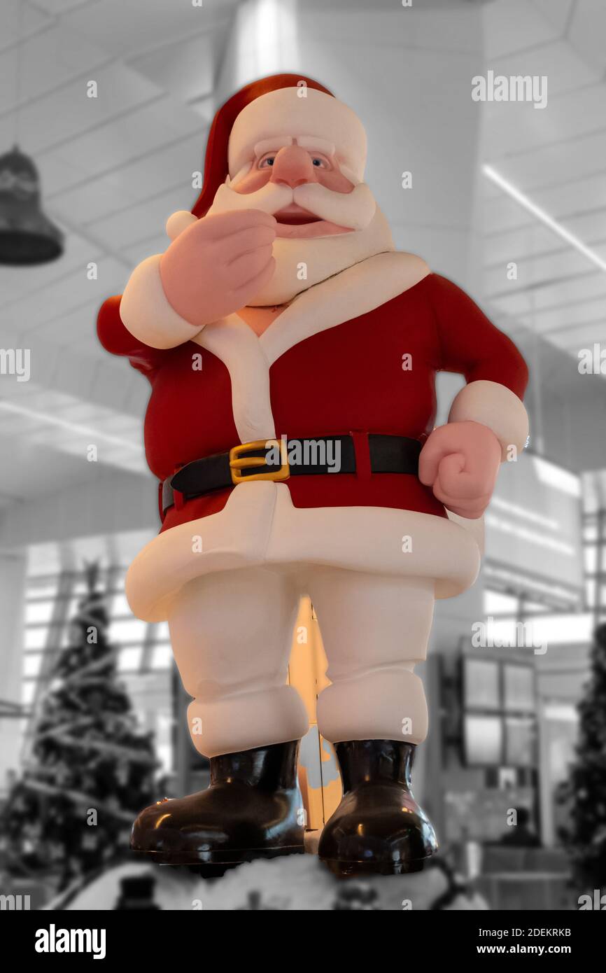 Big Santa Claus idol at mall with christmas tree in background for the christmas celebration. Stock Photo