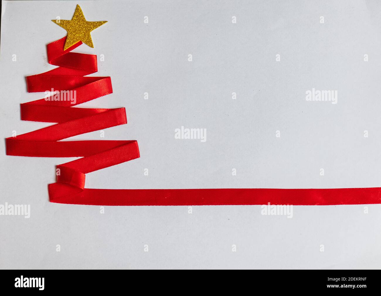 Red Christmas tree made with red ribbon and golden star and christmas ...