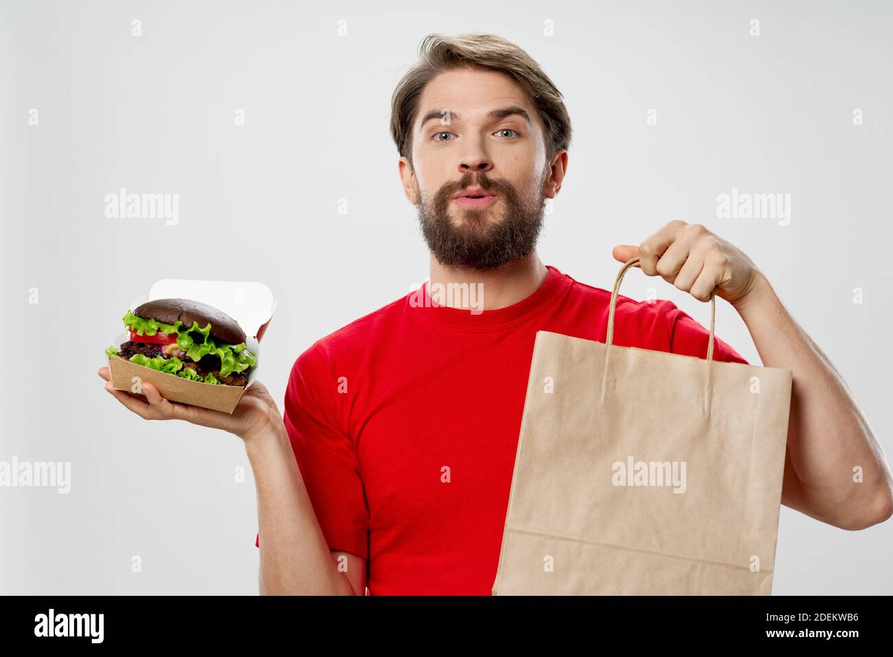 Man Rates Fast Food Man with fast food hamburger food delivery food Stock Photo - Alamy