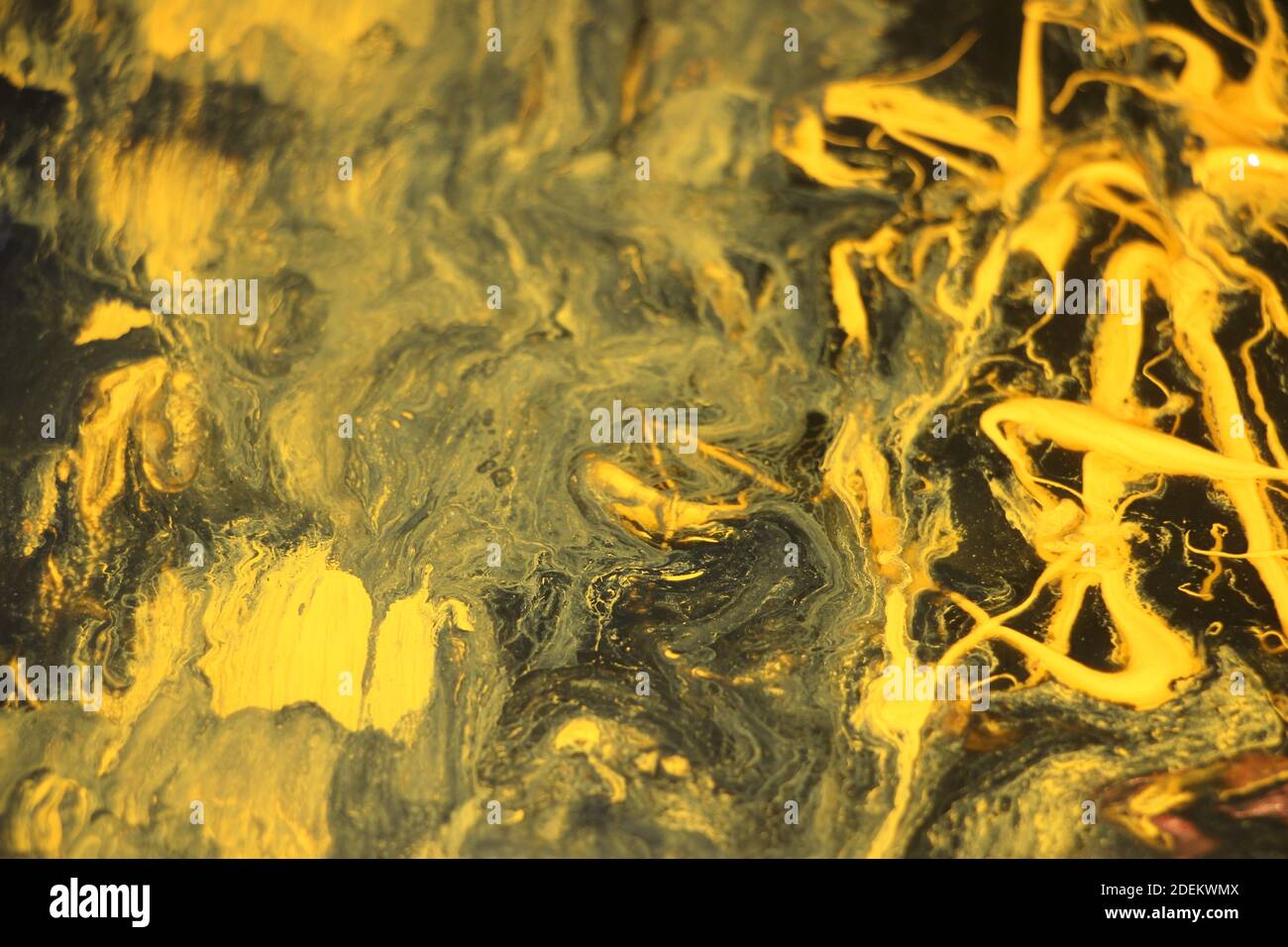 Black and yellow pigments difusion into each other Abstract colorful vivid background Stock Photo