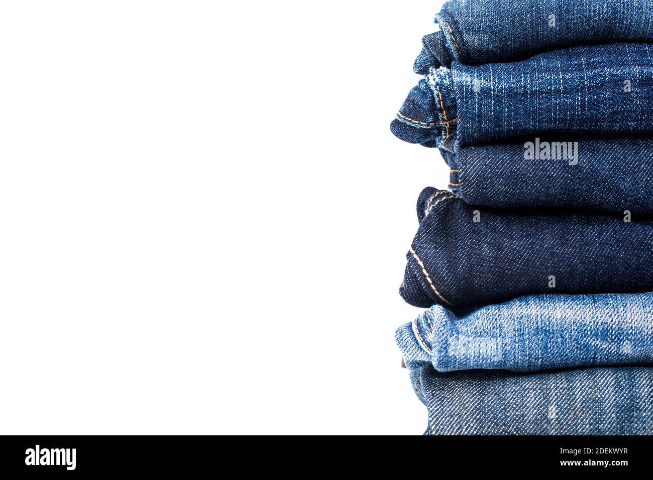 Different colors of blue jeans folded in stack isolated on white ...