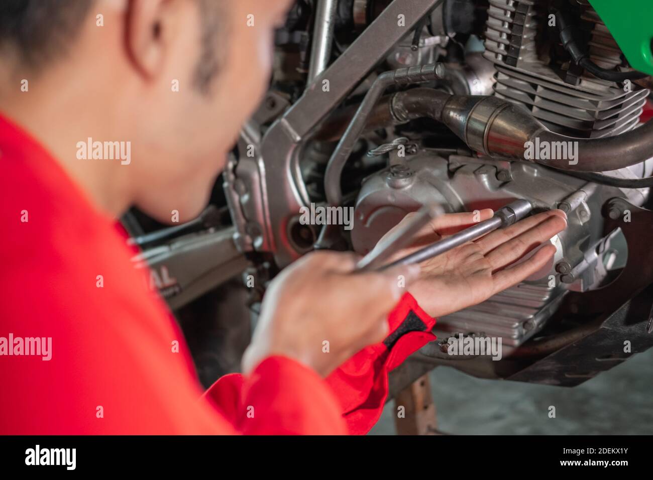 close up of mechanic opening the motor engine bolt using a t socket in ...