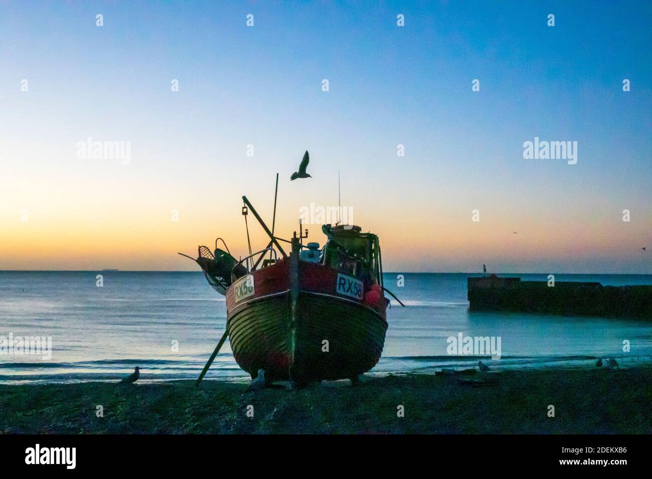 Hastings, East Sussex, UK. 1st December 2020. Hastings fishing boat at dawn on a sunny day on the Old Town Stade fishermen's beach. Carolyn Clarke/Alamy Live News Stock Photo