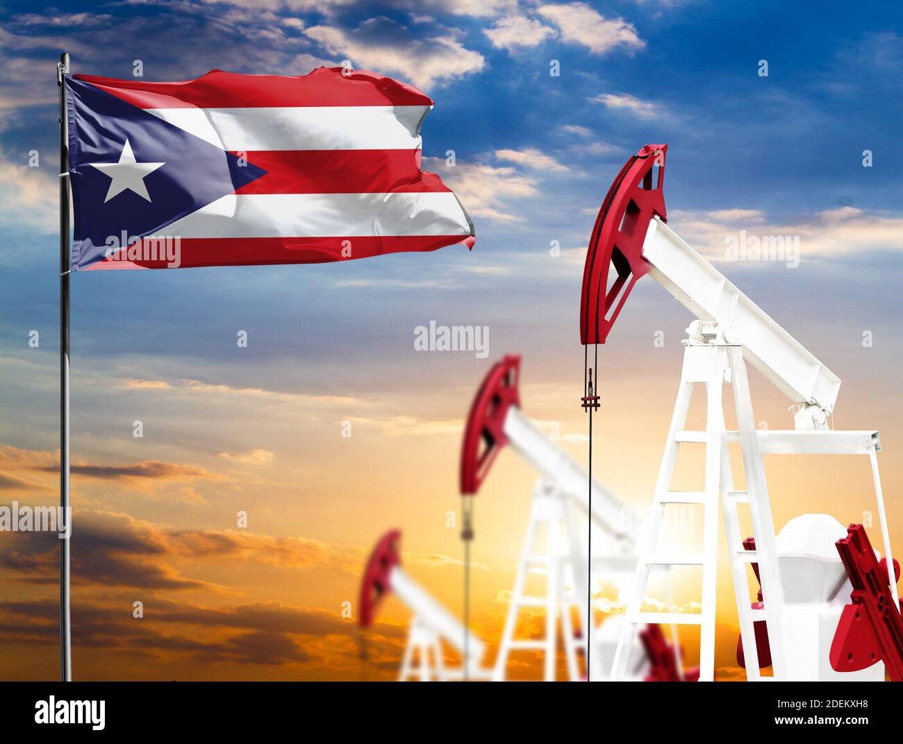 Oil rigs against the backdrop of the colorful sky and a flagpole with