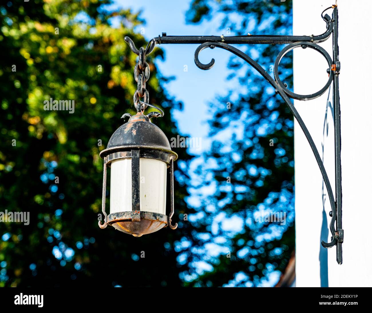 Antique black cast iron lamp hanging of a wall. . High quality photo Stock Photo