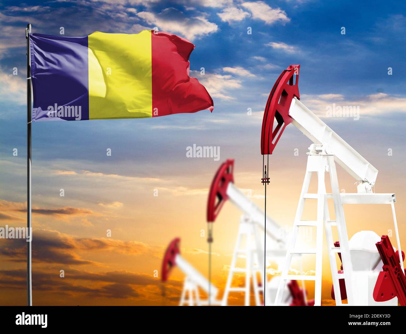 Oil rigs against the backdrop of the colorful sky and a flagpole with ...