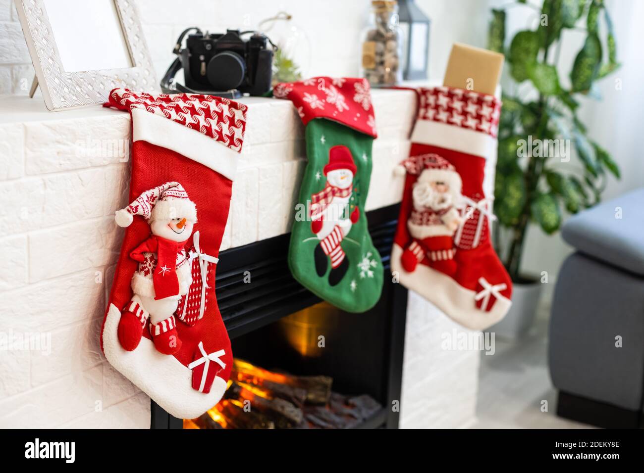 Christmas socks hanging on fireplace in room Stock Photo Alamy