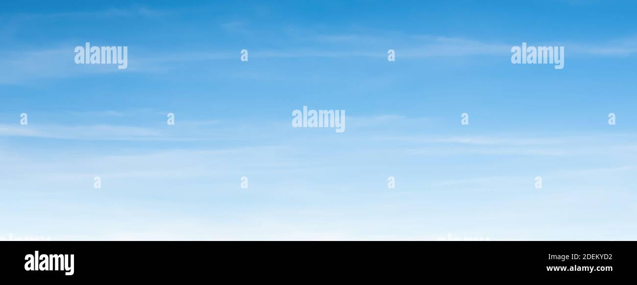An aerial background view from airplane window of clear blue skies and white faint clouds - panoramic web banner Stock Photo