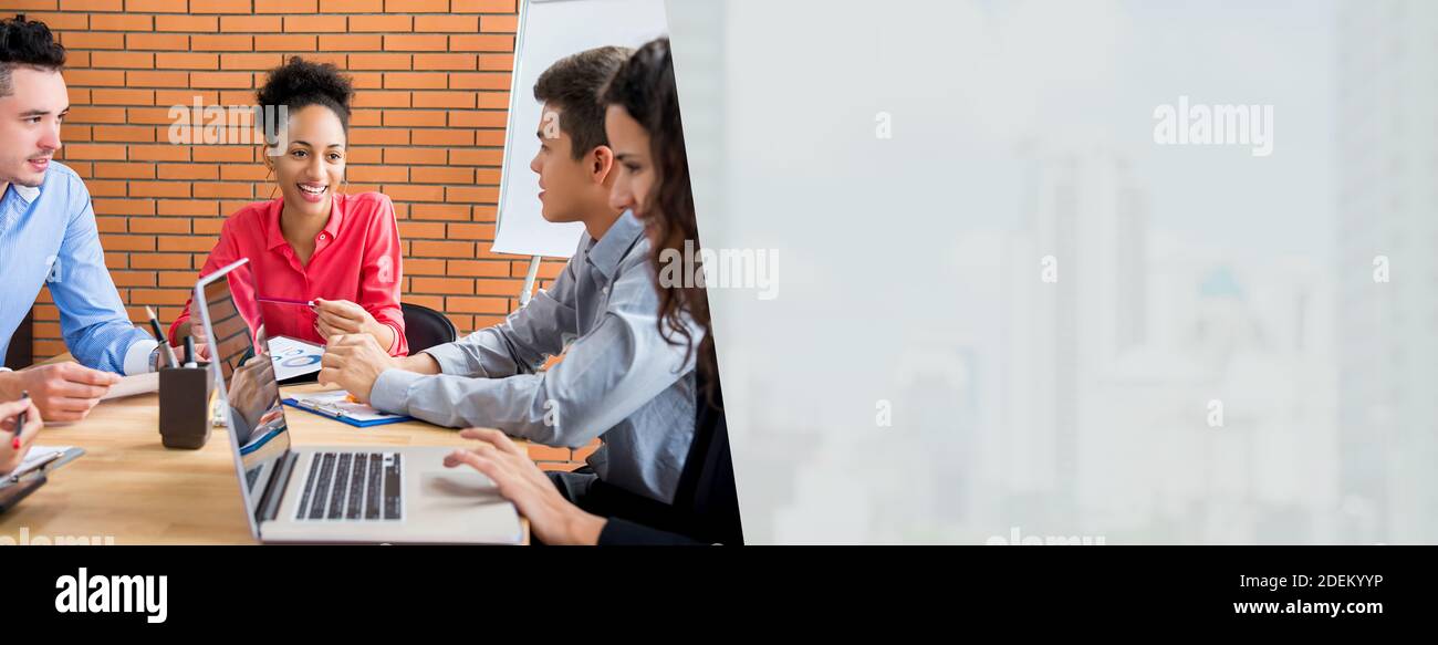 Beautiful happy black businesswoman leader at the meeting with her multiethic colleagues in the office - web banner with gray copy space background fo Stock Photo