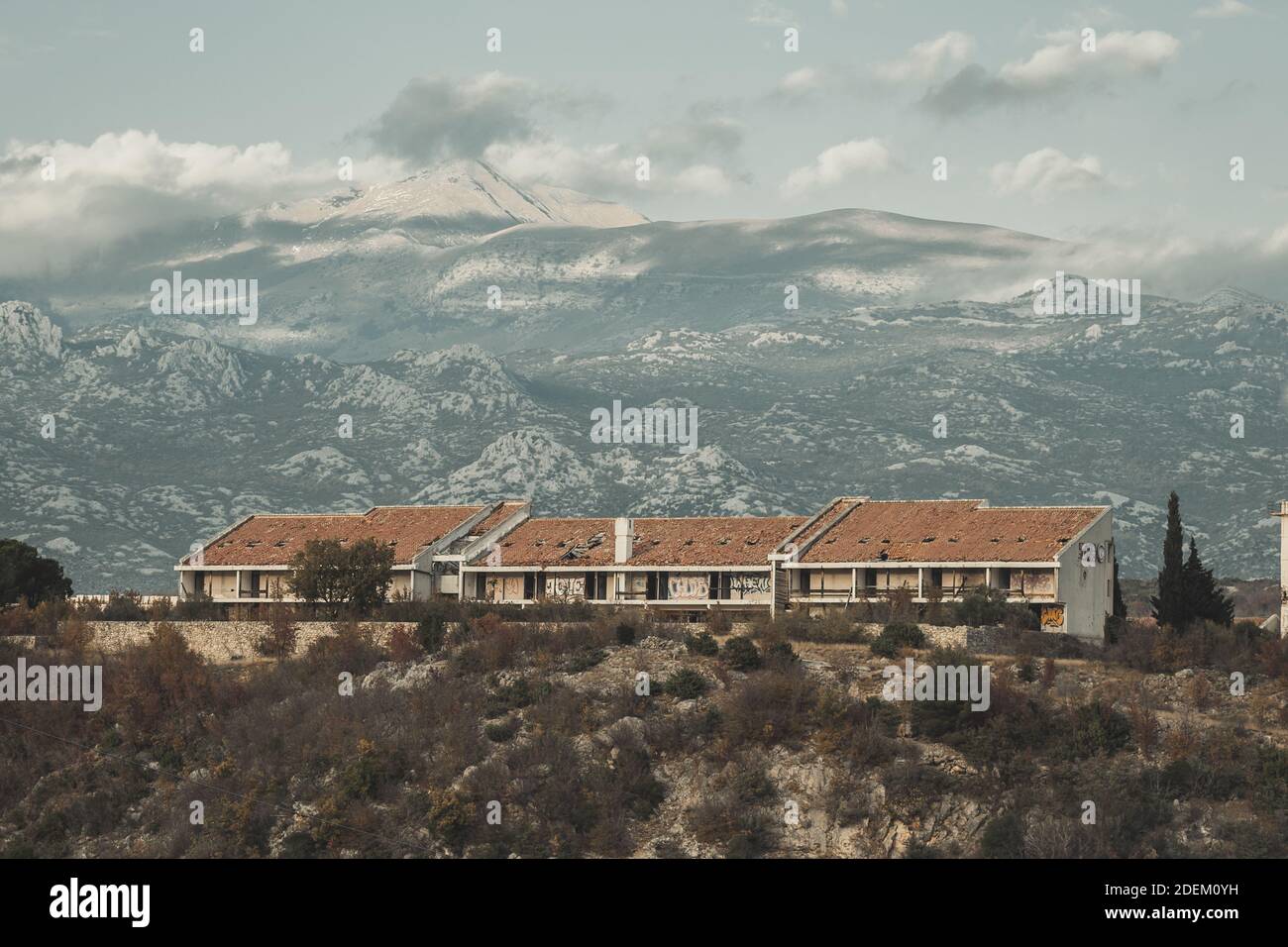 A landscape of abandoned hotel with Velebit mountain range background in Maslenica Stock Photo