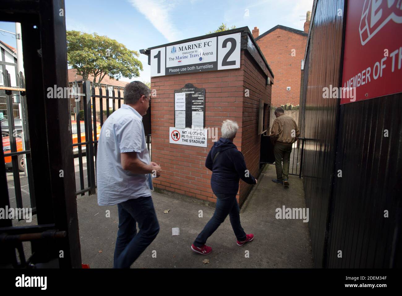 Spectators paying admission at the turnstile at Marine Football Club, pictured before they played host to Ilkeston FC in a Northern Premier League premier division match. The match was won by the home side by 3 goals to 1 and was watched by a crowd of 398. Marine are based in Crosby, Merseyside and have played at Rossett Park since 1903, the club having been formed in 1894. Stock Photo