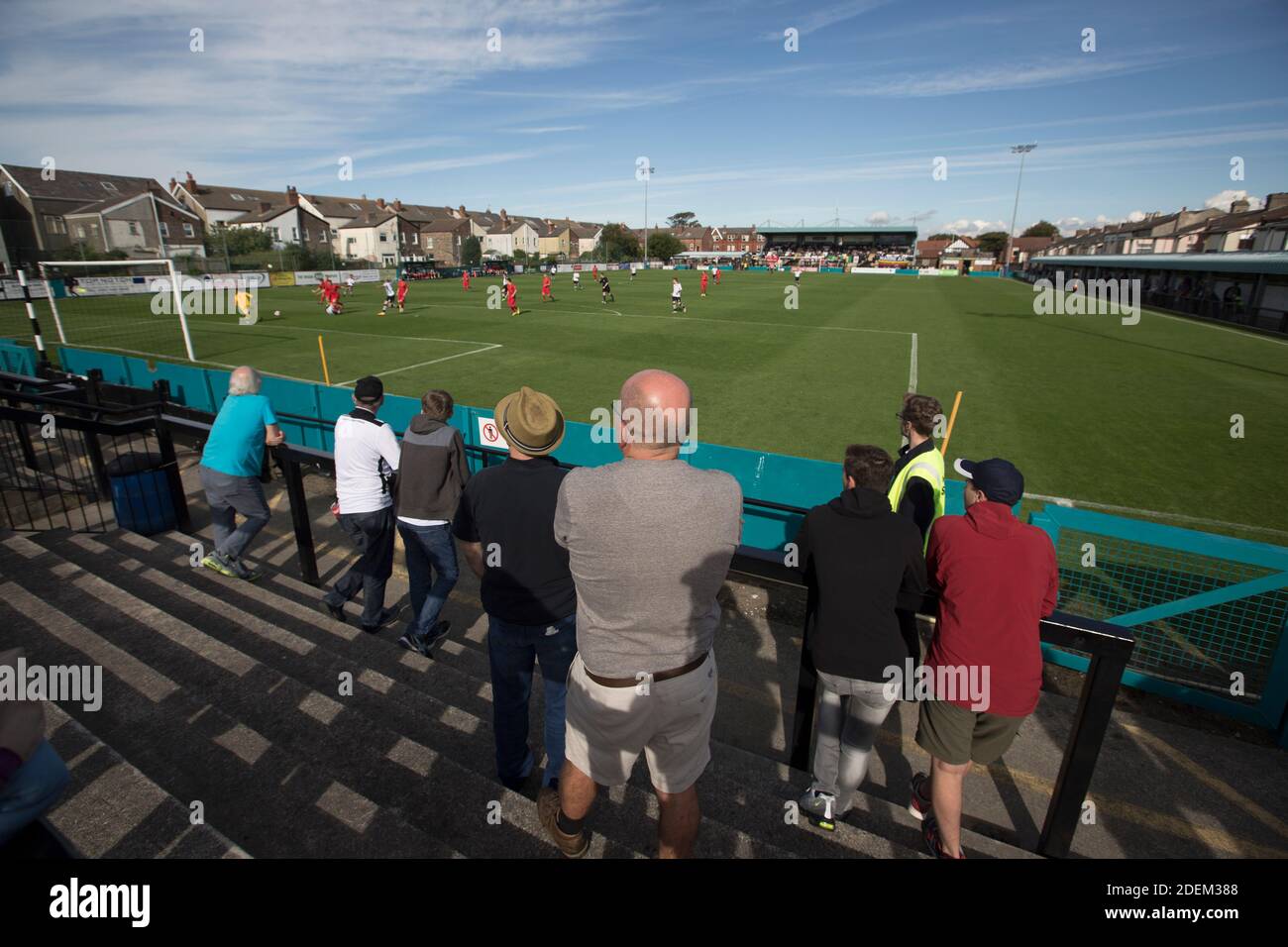 Home supporters watching the early action as Marine Football Club (in white), play Ilkeston FC in a Northern Premier League premier division match. The match was won by the home side by 3 goals to 1 and was watched by a crowd of 398. Marine are based in Crosby, Merseyside and have played at Rossett Park since 1903, the club having been formed in 1894. Stock Photo