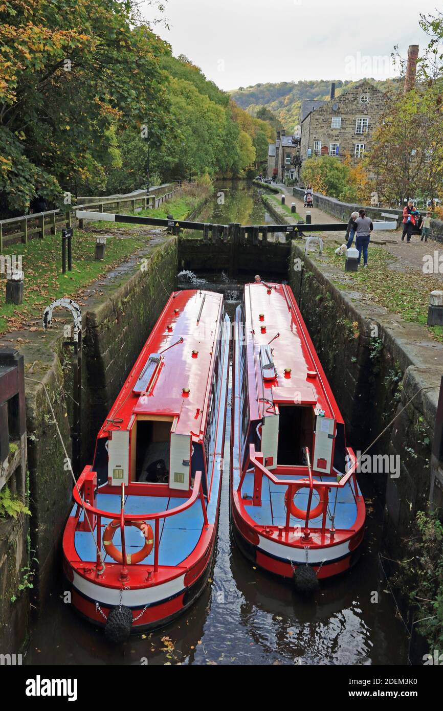2 Narrowboats in Black Pit lock, Rochdale canal, Hebden Bridge Stock Photo