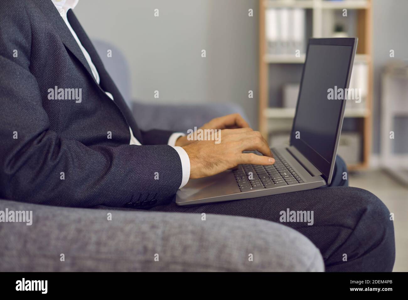 Businessman typing on laptop keyboard, entering data into database or ...