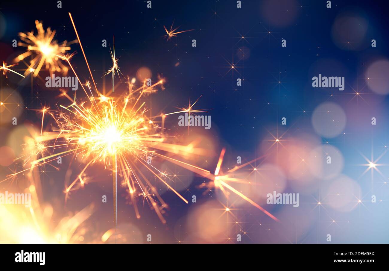 Glittering sparkler against bokeh light background with copy space Stock Photo