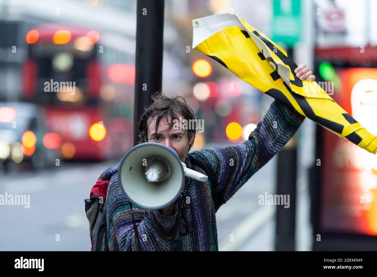 Anti-lockdown protest, London, 28 November 2020. A protester speaks into a megaphone on Oxford Street. Stock Photo