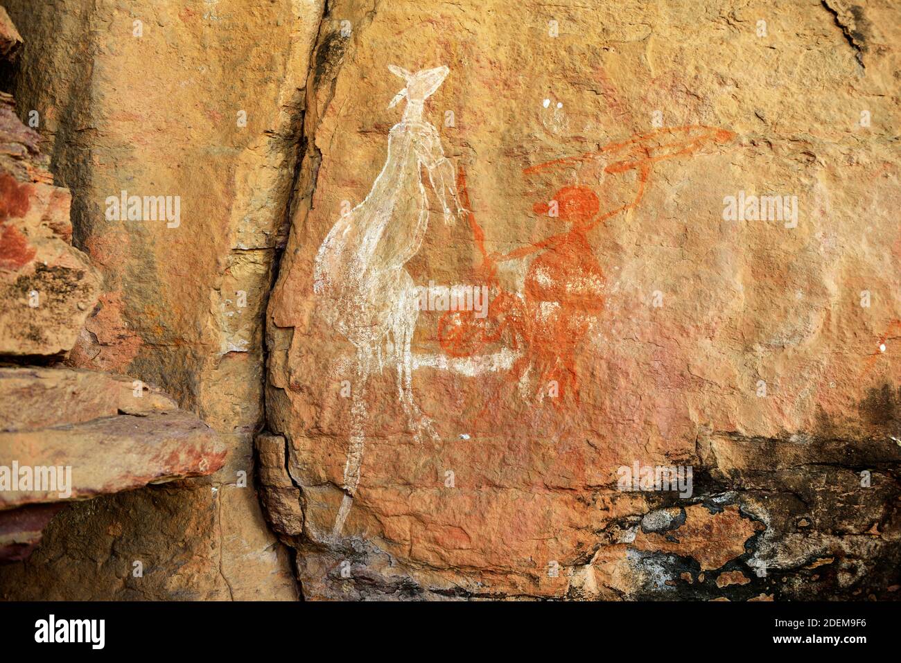 Ancient aboriginal painting art, representing man hunting kangaroo, on huge rock stone in Kakadu park, northern territory, Australia. Stock Photo