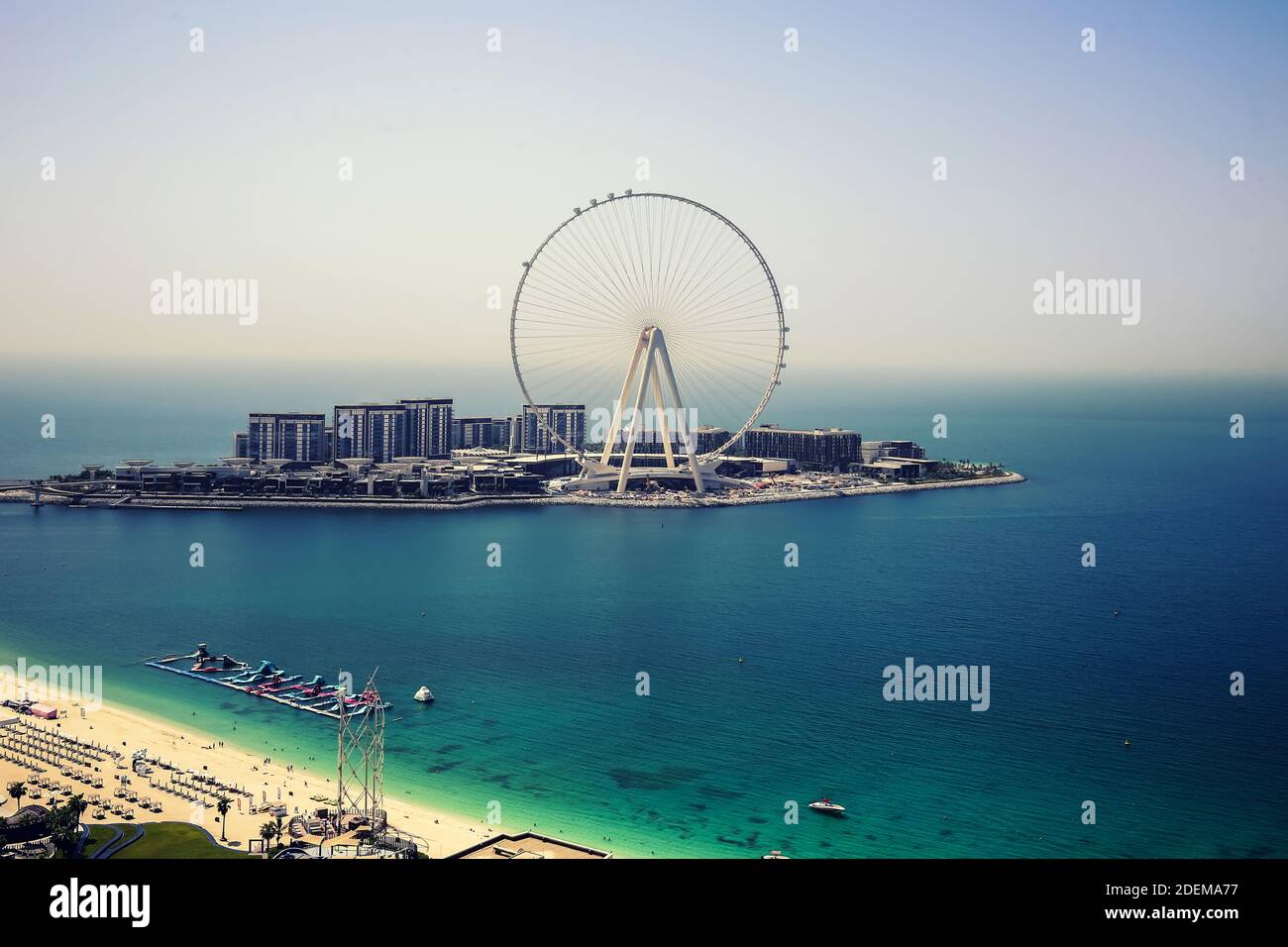 Dubai ferris wheel on Bluewaters island during day with nine installed cabins and part of Jumeirah beach Stock Photo