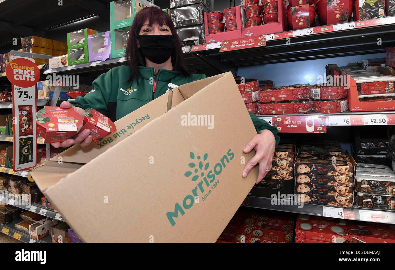 EDITORIAL USE ONLY A staff member assembles 'The Christmas Dinner for Two Box' from Morrisons supermarket, which can be ordered from its new dedicated Doorstep Deliveries phone line, enabling vulnerable or self-isolating customers to order their groceries and have them hand-delivered from their local store. Stock Photo