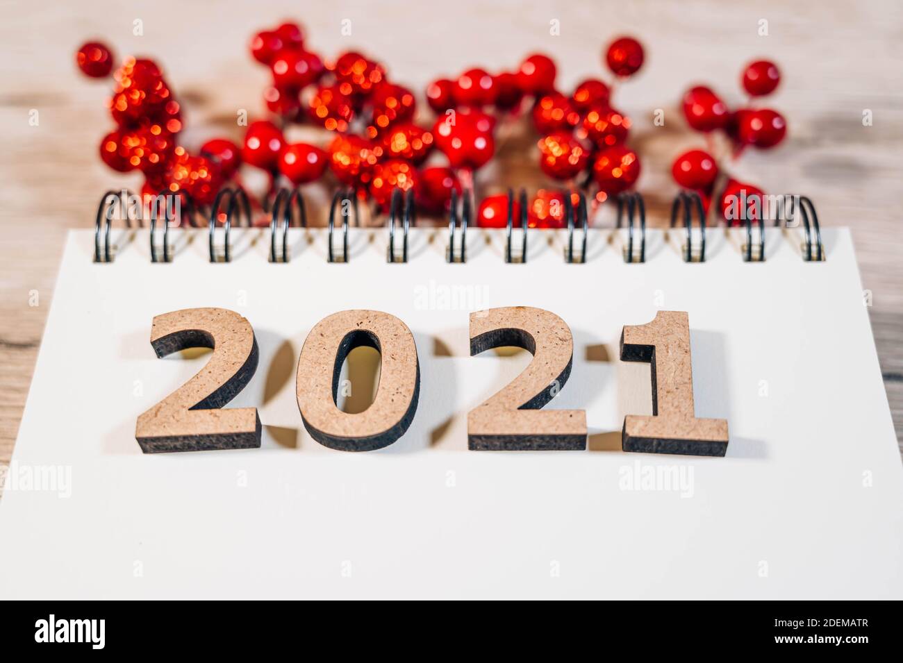 Goals and new years resolution concept. New year 2021 goals list. Blank notebook, wooden numbers 2021 and christmas decorations isolated on a wood Stock Photo