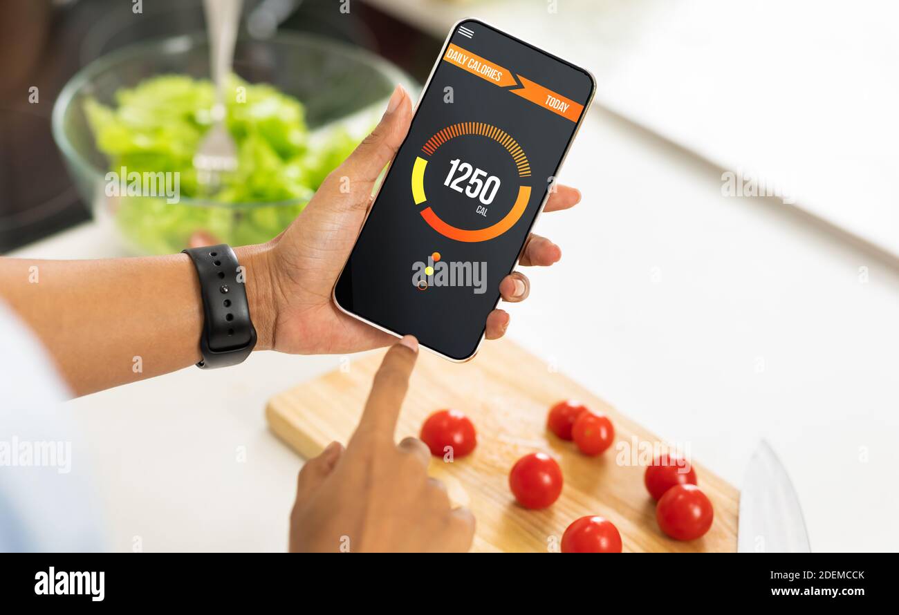 Calories counting, food control and consumer nutrition facts label concept.  doughnut and croissant on white plate with tongue scales for Calories meas  Stock Photo - Alamy