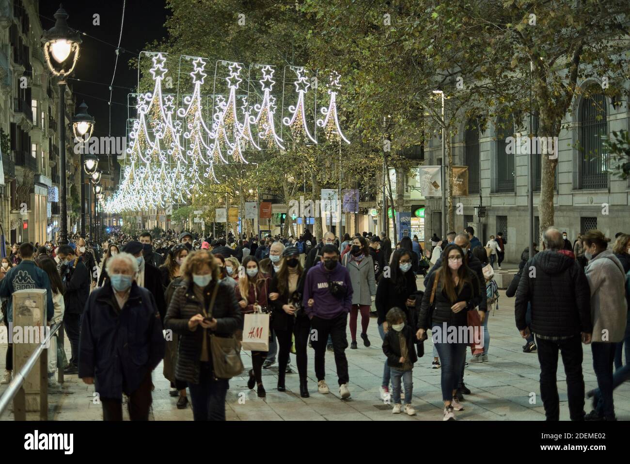 BARCELONA, CATALONIA, SPAIN - NOVEMBER 28, 2020: Portal del Angel full of people at night with decoration of lights welcoming Christmas in Barcelona Stock Photo