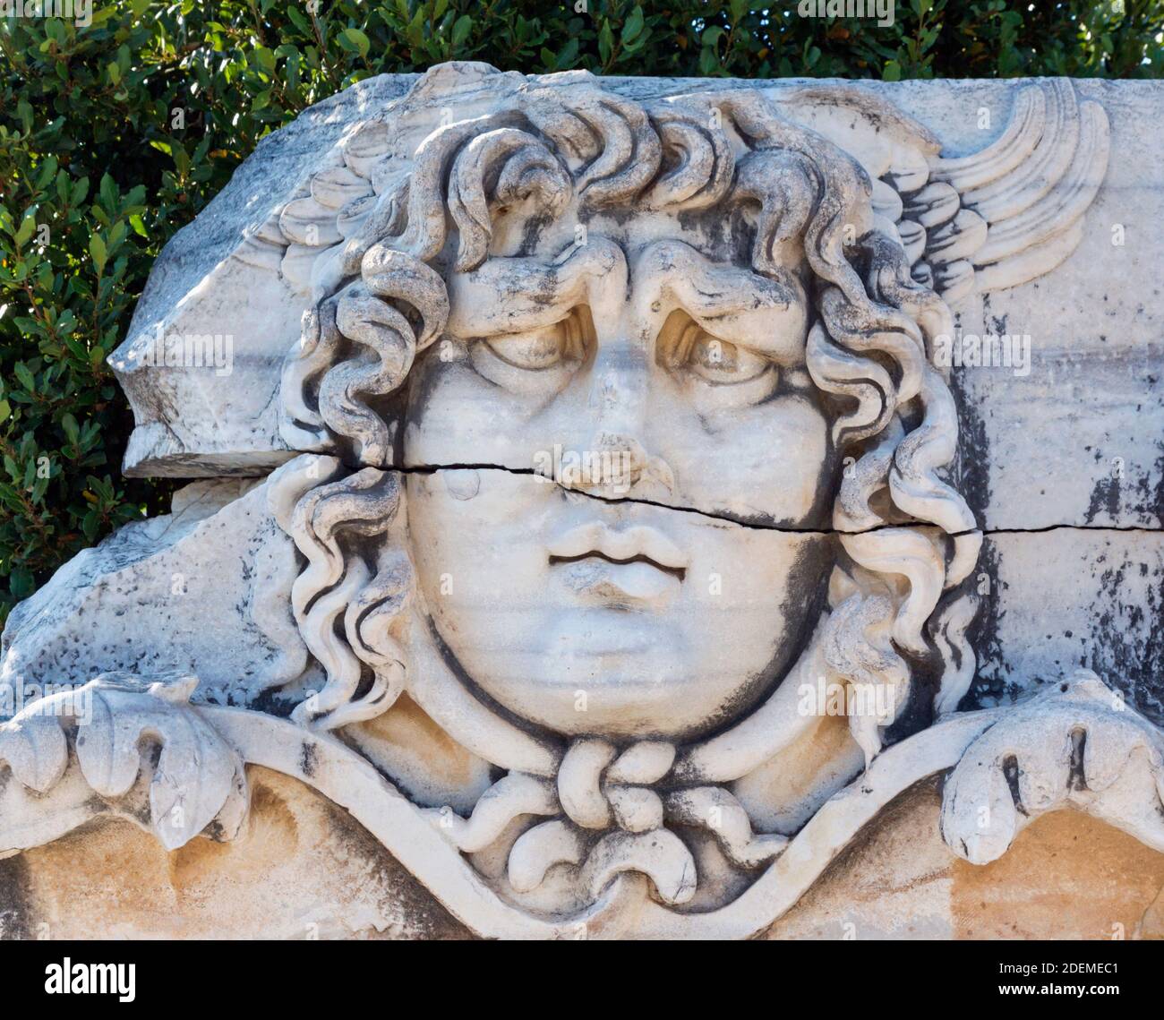 Ruins of ancient Didyma at Didim, Aydin Province, Turkey.  Carved relief of the head of Medusa. Stock Photo