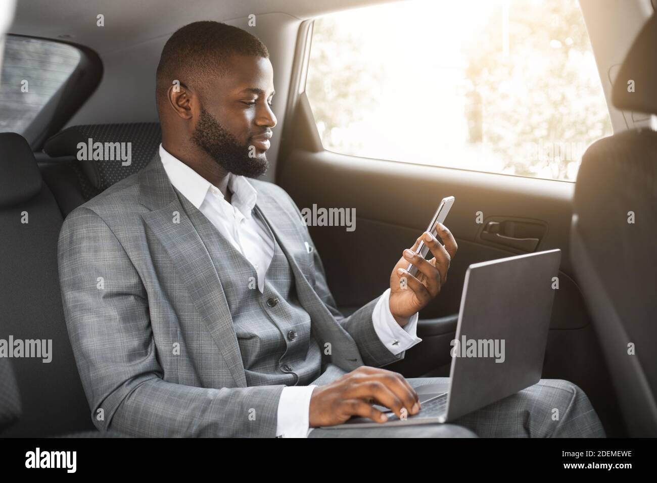 African businessman using smartphone laptop hi-res stock photography ...