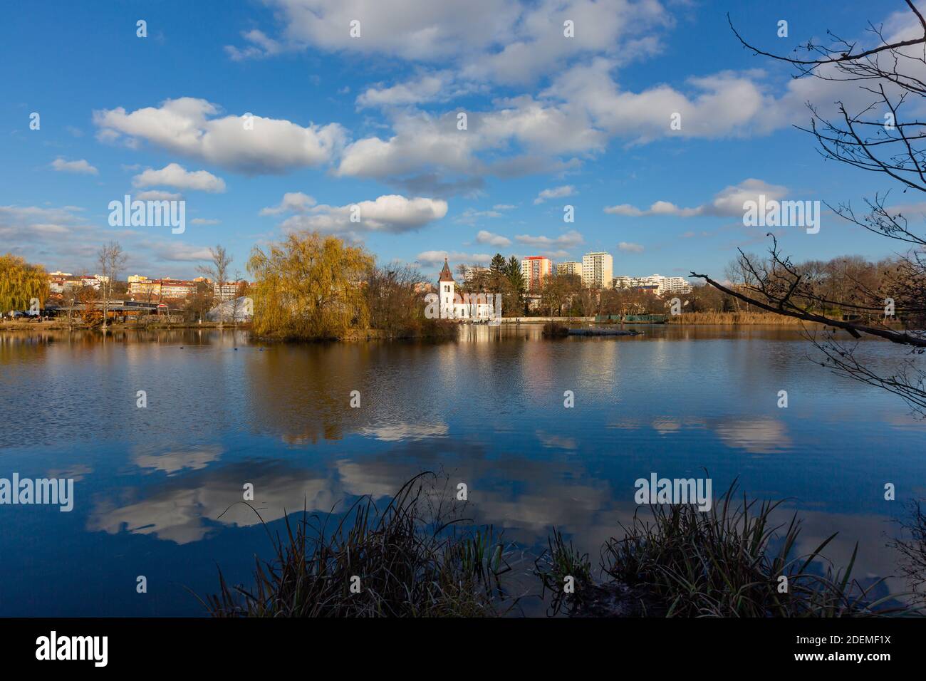Prauge, Czech Republic - November 30 2020: View of the Hamersky pond and church of Nativity of Mary and houses over the water with reflection in water. Stock Photo