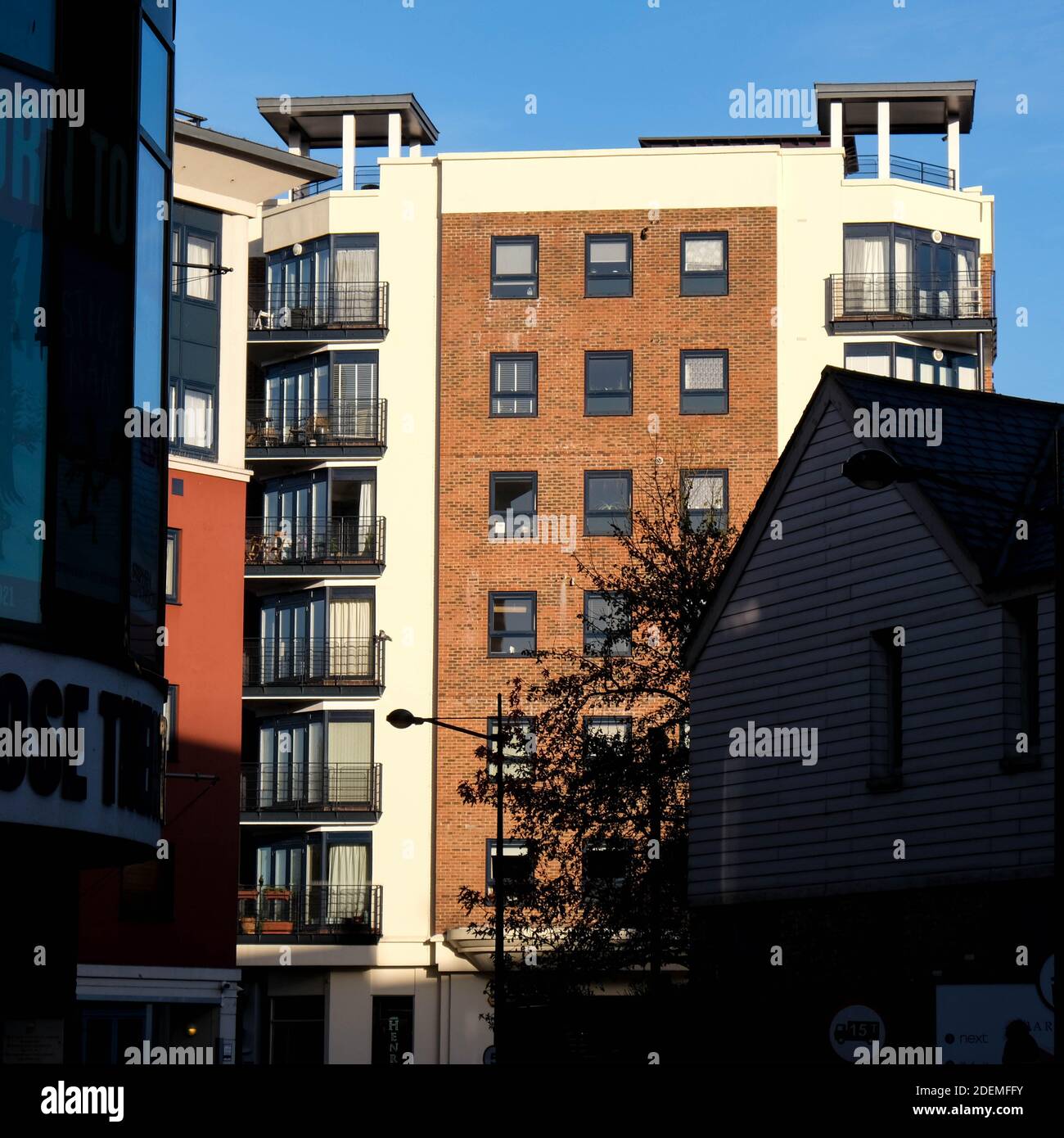 London UK, December 01 2020, New Residential Apartment Building Against A Clear Blue Sky Caught In Mornig Sunlight Stock Photo