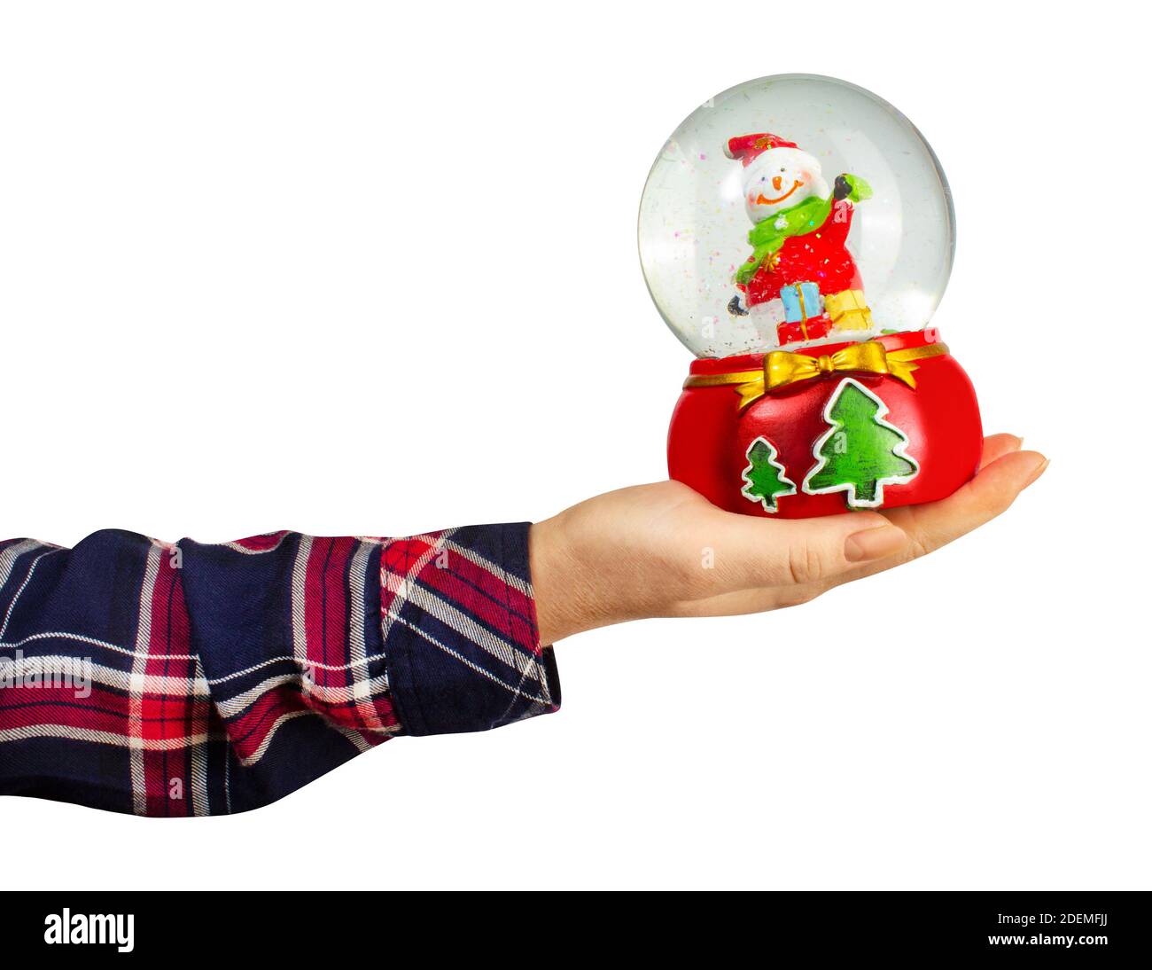 Isolated photo of a girl hand in shirt holding christmas decorative snowball toy on white background. Stock Photo