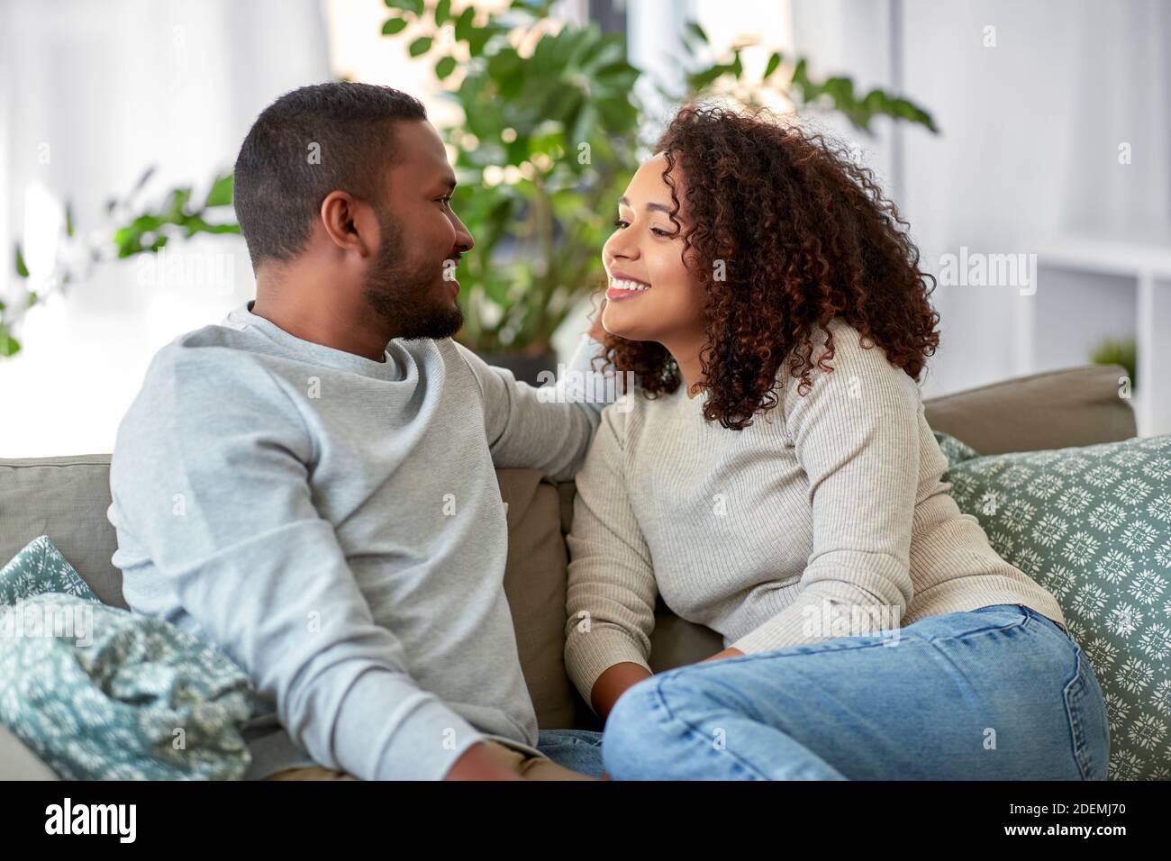 african american couple on sofa talking at home Stock Photo - Alamy