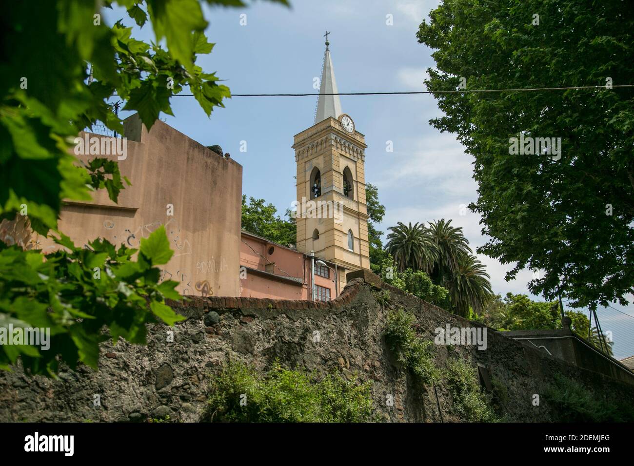 Italian seen of a Cathedral surrounded by a garden and a brick wall Stock Photo